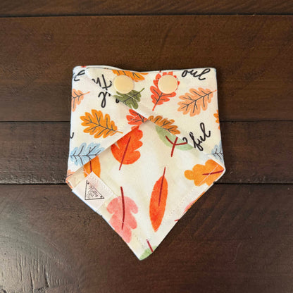 Feeling Thankful pet bandana showing a multicolored autumn leaf reverse and cream snaps.