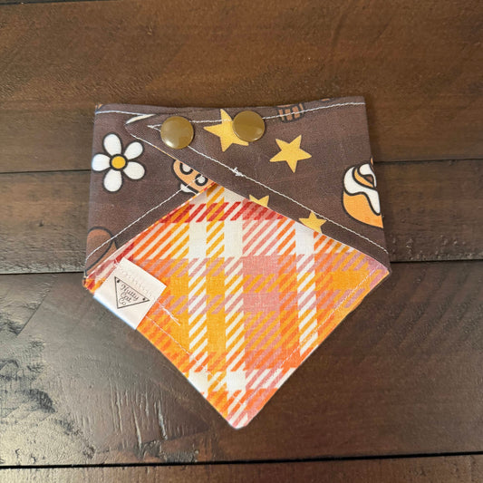 Dark chocolate brown pet bandana with an apple button, autumn leaf, lamp, shoe, and iced cinnamon roll.