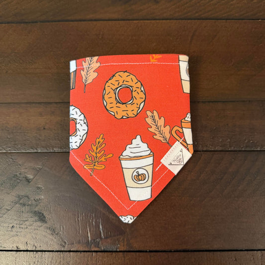 Orange pet bandana with frosted donuts, pumpkin coffee cups, and autumn leaves.